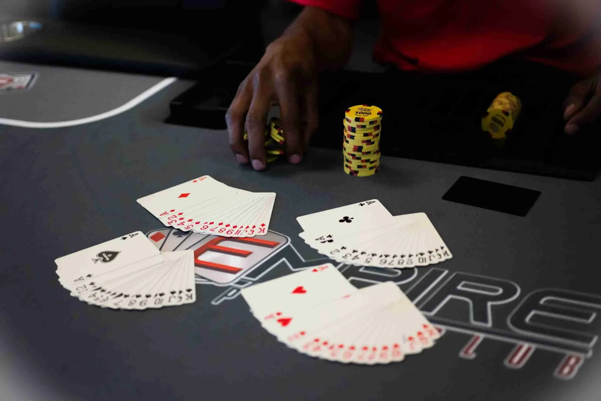 Empire Poker Club logo on table with cards and chips